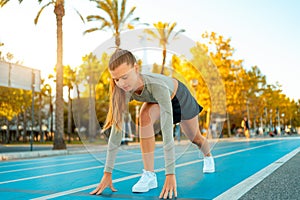 Sportswoman amateur on starting line running track