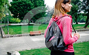 Sportswoman with backpack going to the gym