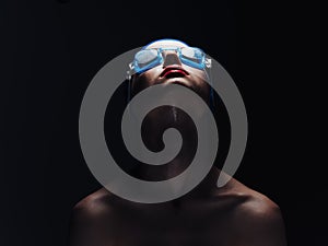Sportswoman on a black background in goggles for swimming portrait close-up
