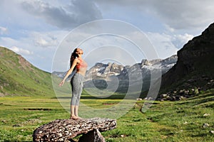 Sportswoman breathing fresh air in a beautiful mountain