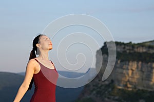 Sportswoman breathing fresh air in the mountain