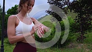 sportswoman is checking health parameters in smart watch after workout in nature, fitness tracker