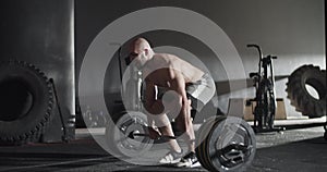 Sportswoman doing unsuccessful attempt during deadlift exercise