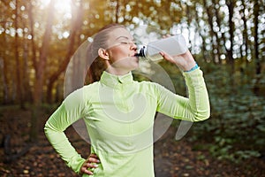 Sportswoman drinking isotonic drink