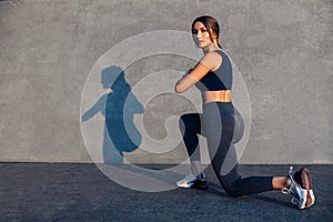 Sportswoman enjoying workout squatting, lower body and leg muscles workout, fitness woman doing squatting exercises