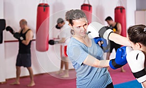 Sportswoman is having sparring with partner