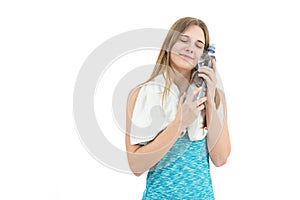 Sportswoman holding a bottle of water to cool down to her face