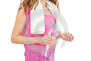 Sportswoman holding a water bottle in her hand