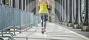 Sportswoman jogging on Pont de Bir-Hakeim bridge in Paris