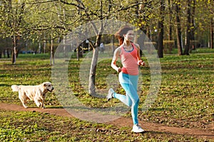 Sportswoman with labrador in park