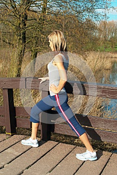 Sportswoman Lunging Outdoors.