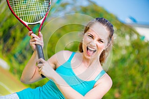 Sportswoman with racket at the tennis court