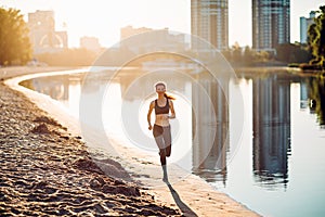 Sportswoman run on riverbank at sunrise