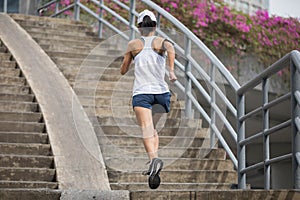 sportswoman running up city stairs