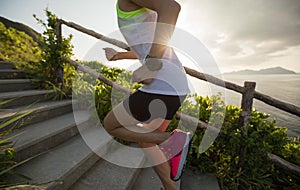 Sportswoman running up on seaside