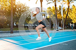 Sportswoman on starting line running track