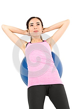 Sportswoman training her abs on pilates ball