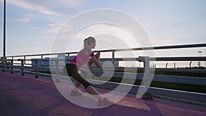 sportswoman is training in urbanistic landscape, doing morning exercises