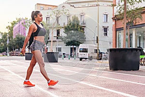 sportswoman walking on a city athletics track