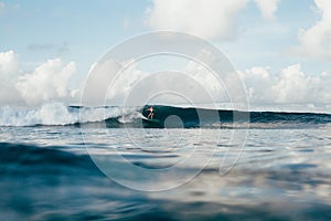 sportswoman in wetsuit having fun while surfing