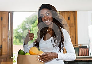 Sporty african american woman with fresh and healthy fruits