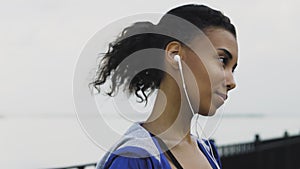 Sporty Afro-american woman stretching neck and warm-up before jogging