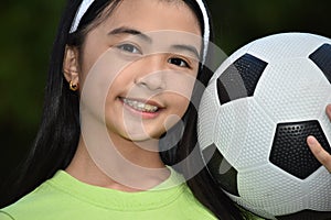 Sporty Asian Child Soccer Player Smiling With Soccer Ball