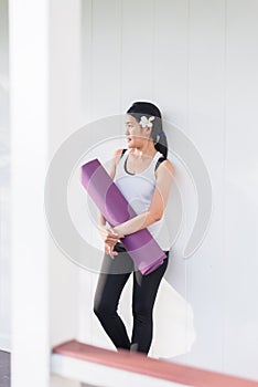 Sporty asian female hands holding yoga mat after a workout,Exercise equipment,Healthy fitness and sport concept