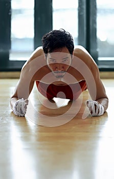 Sporty asian man doing push ups exercise