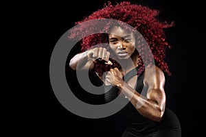 Sporty beautiful afro-american model, woman in sportwear makes fitness exercising at black background to stay fit