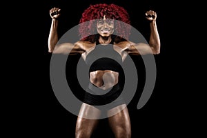 Sporty beautiful afro-american model, woman in sportwear makes fitness exercising at black background to stay fit