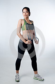 Sporty beautiful woman with skip rope