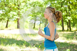 Sporty blonde girl doing fitness outdoor