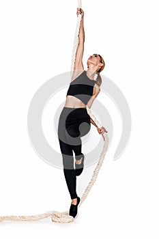 Sporty blonde woman in sportswear with rope