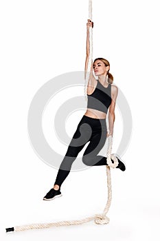 Sporty blonde woman in sportswear with rope