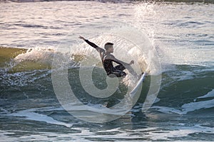Sporty boy riding his surf board