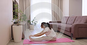 sporty caucasian woman doing exercises at home.