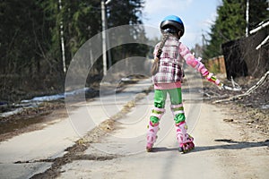 Sporty child girl on roller skates