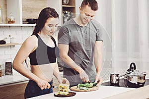 Sporty couple cooking healthy food together