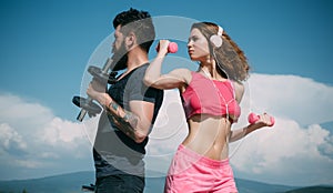 Sporty couple. Start daily workout. Sexy slim active couple with straight body sportswear outdoor blue sky background