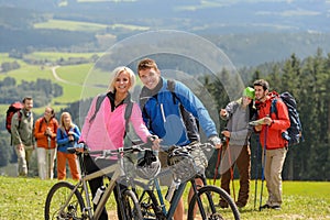 Sporty cyclist couple hikers springtime weekend