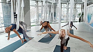 Sporty diverse women have fly yoga training