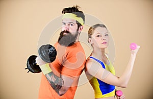 Sporty family. Healthy lifestyle concept. Man and woman exercising with dumbbells. Fitness exercises with dumbbells