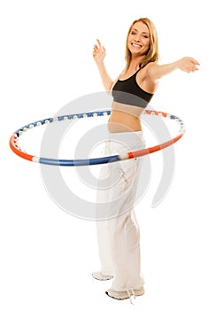 Sporty fit girl doing exercise with hula hoop.