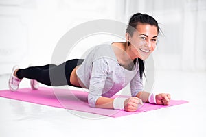 Sporty fit sliming girl doing plank exercise in