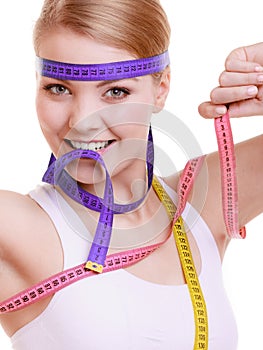 Sporty fit woman with measure tapes. Time for diet slimming.