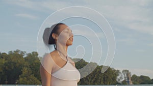 Sporty fit woman working out with jump rope at dawn