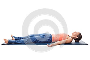 Sporty fit yogi girl relax in yoga asana Savasana
