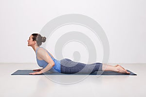 Sporty fit yogini woman practices yoga asana