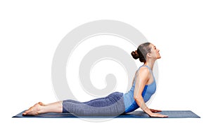 Sporty fit yogini woman practices yoga asana bhujangasana